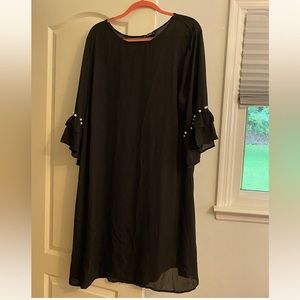 Black knee length dress with pearls on sleeve